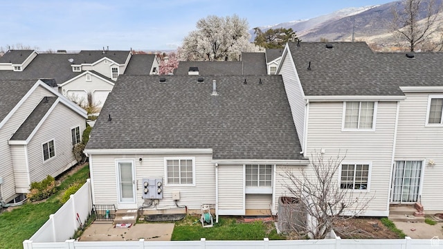 499 N 200 W Unit 8, Bountiful, UT 84010 - back of house featuring a fenced backyard, a shingled roof, entry steps, and a mountain view