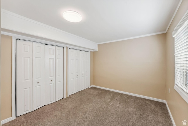 499 N 200 W Unit 8, Bountiful, UT 84010 - unfurnished bedroom featuring baseboards, multiple closets, crown molding, and carpet flooring