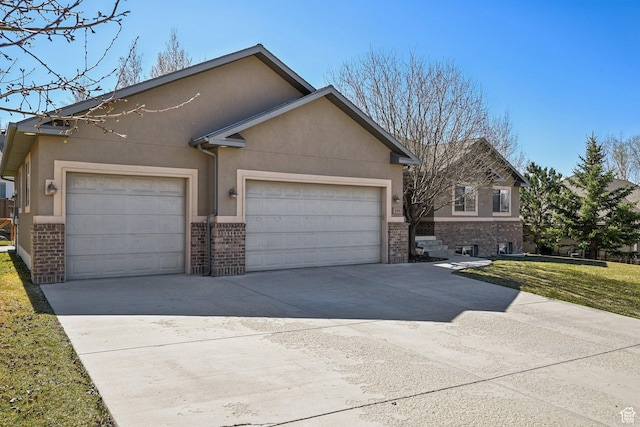 664 E Oak Wood Dr N Unit 50, Heber City, UT 84032 - view of front of house with concrete driveway, stucco siding, a front lawn, brick siding, and a garage