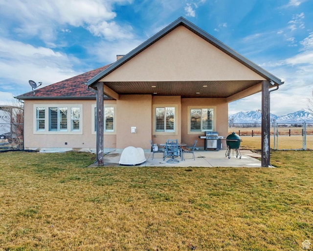 546 S Quirk St, Grantsville, UT 84029 - rear view of house featuring a patio area, stucco siding, fence, and a lawn