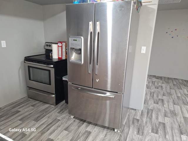 546 S Quirk St, Grantsville, UT 84029 - kitchen featuring light wood-style floors and appliances with stainless steel finishes