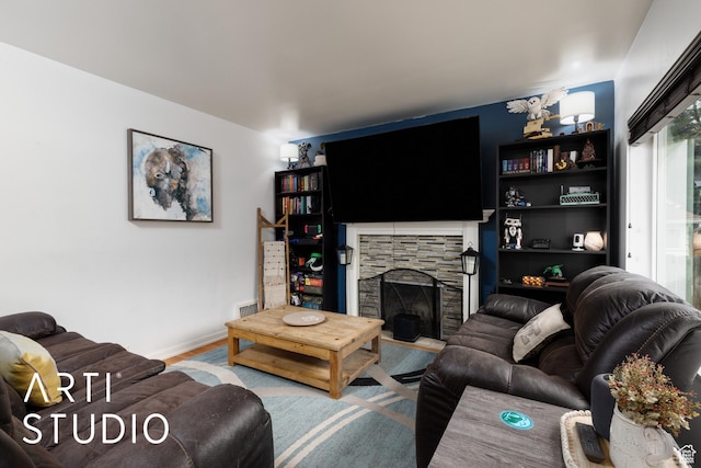 2209 Van Buren Ave, Ogden, UT 84401 - living area featuring baseboards, wood finished floors, and a stone fireplace