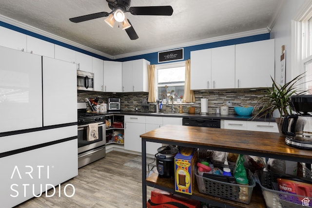 2209 Van Buren Ave, Ogden, UT 84401 - kitchen featuring tasteful backsplash, ornamental molding, stainless steel appliances, a sink, and light wood finished floors