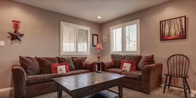 living area with baseboards, light colored carpet, and recessed lighting