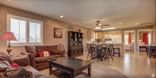 living area featuring ceiling fan, recessed lighting, light tile patterned floors, and plenty of natural light