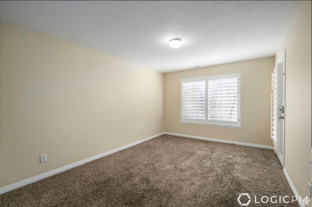 unfurnished bedroom with a textured ceiling, carpet floors, and baseboards