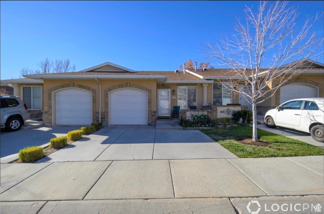 view of front of home featuring stucco siding, driveway, and a garage