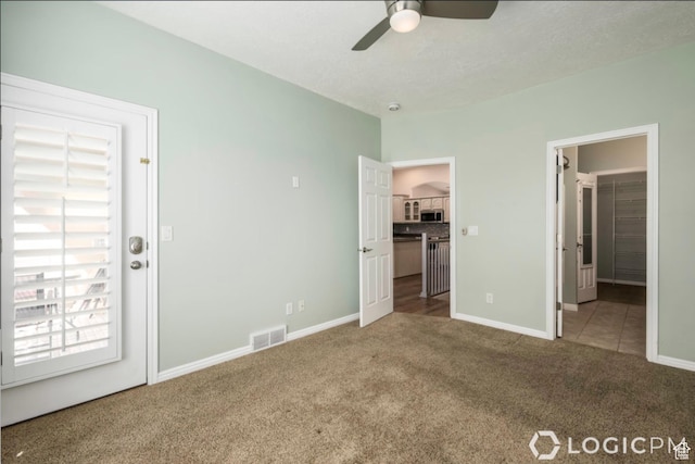 unfurnished bedroom with carpet, baseboards, visible vents, connected bathroom, and a spacious closet