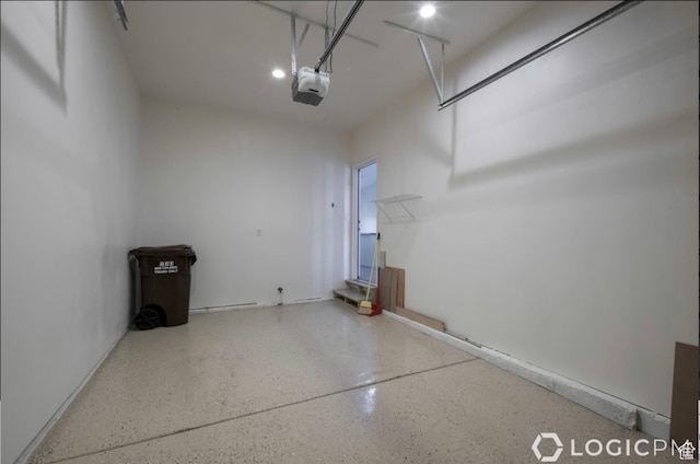 garage featuring recessed lighting and a garage door opener