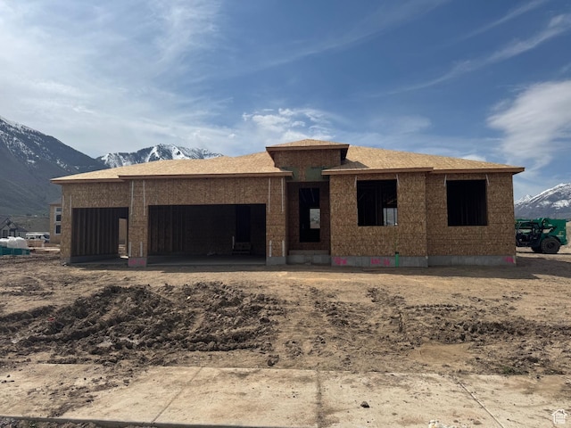property in mid-construction featuring an attached garage and a mountain view