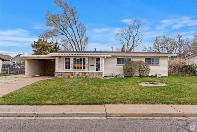 ranch-style house with stone siding, fence, a front lawn, driveway, and a carport