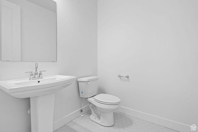 3666 W 2110 S Unit 103, Syracuse, UT 84075 - bathroom with baseboards, toilet, tile patterned floors, and a sink