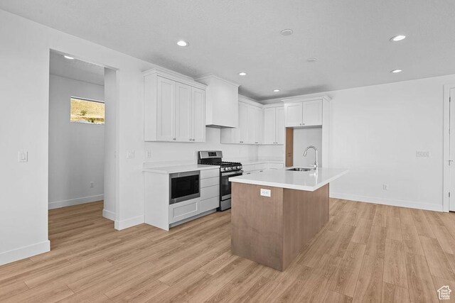 3666 W 2110 S Unit 103, Syracuse, UT 84075 - kitchen with a sink, light wood-style floors, stainless steel gas stove, and built in microwave