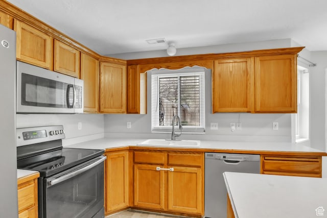565 N Lynnbrook Dr, Spanish Fork, UT 84660 - kitchen with light countertops, stainless steel appliances, a sink, visible vents, and brown cabinetry