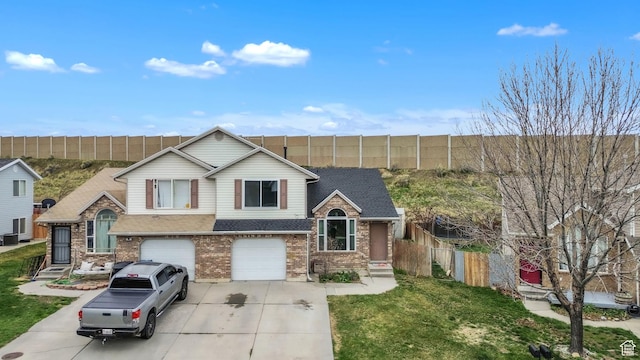 565 N Lynnbrook Dr, Spanish Fork, UT 84660 - tri-level home with fence, an attached garage, central AC, brick siding, and driveway
