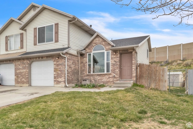 view of front of property with driveway, brick siding, fence, and a garage