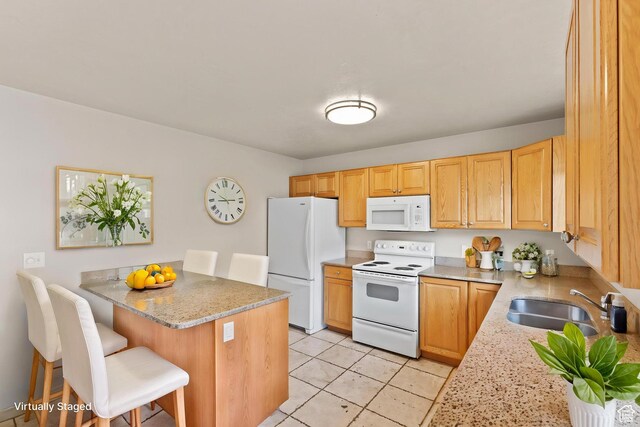 1762 N 460 W Unit 103-10, Logan, UT 84341 - kitchen featuring white appliances, a peninsula, light stone countertops, a kitchen bar, and a sink