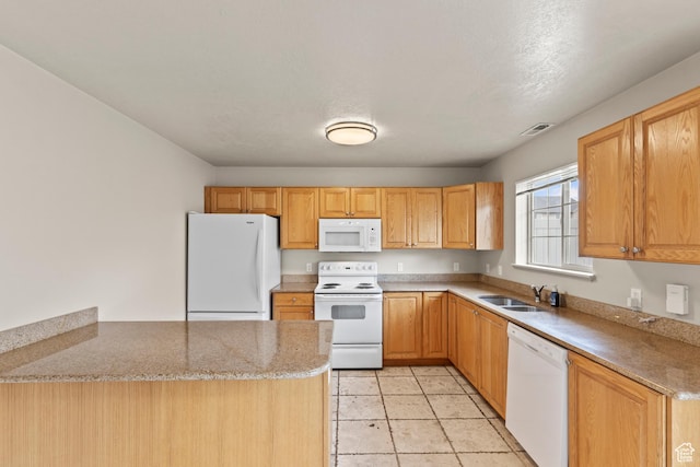 1762 N 460 W Unit 103-10, Logan, UT 84341 - kitchen with light stone counters, white appliances, a peninsula, visible vents, and a sink