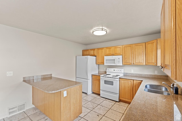 1762 N 460 W Unit 103-10, Logan, UT 84341 - kitchen with visible vents, a sink, white appliances, a peninsula, and light tile patterned flooring