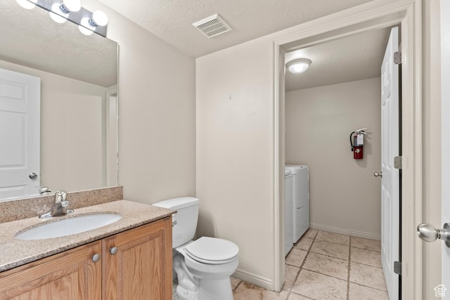 1762 N 460 W Unit 103-10, Logan, UT 84341 - half bath with washer / clothes dryer, vanity, visible vents, toilet, and baseboards