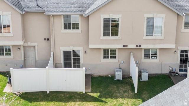 1762 N 460 W Unit 103-10, Logan, UT 84341 - back of property with roof with shingles, a yard, and stucco siding