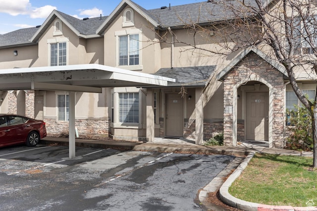 1762 N 460 W Unit 103-10, Logan, UT 84341 - view of front of home with covered parking, stucco siding, and stone siding