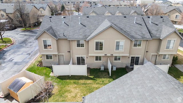 1762 N 460 W Unit 103-10, Logan, UT 84341 - rear view of house with a yard, a fenced backyard, stucco siding, a residential view, and roof with shingles
