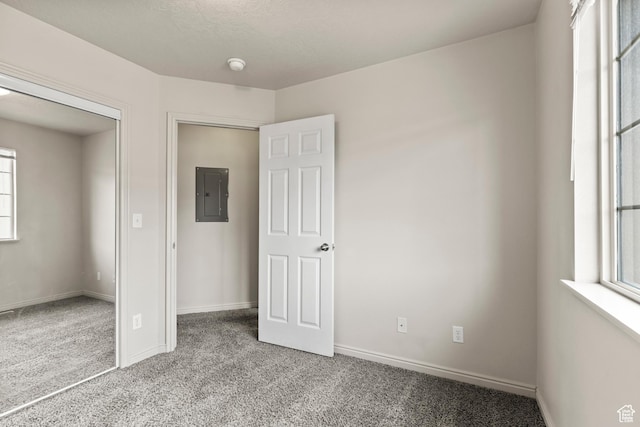 1762 N 460 W Unit 103-10, Logan, UT 84341 - unfurnished bedroom with baseboards, multiple windows, carpet, and electric panel