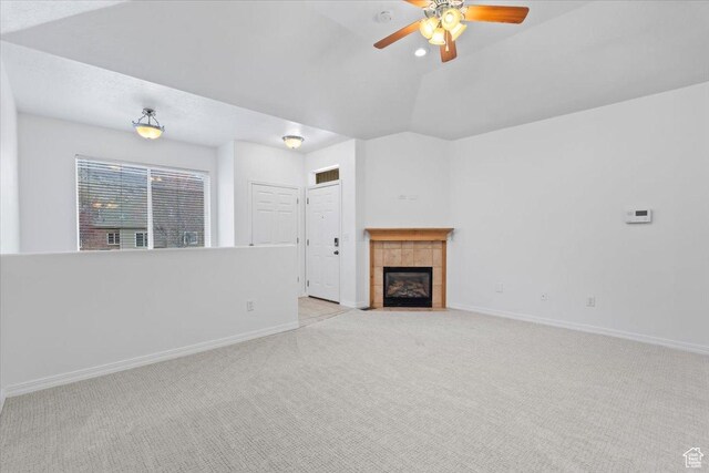 9587 N 4500 W, Cedar Hills, UT 84062 - unfurnished living room featuring vaulted ceiling, light colored carpet, baseboards, ceiling fan, and a tile fireplace