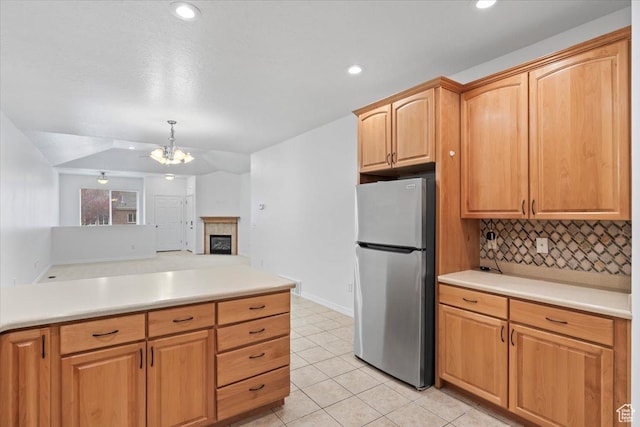 9587 N 4500 W, Cedar Hills, UT 84062 - kitchen featuring light tile patterned flooring, light countertops, a chandelier, backsplash, and freestanding refrigerator