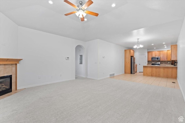 9587 N 4500 W, Cedar Hills, UT 84062 - unfurnished living room featuring light carpet, ceiling fan with notable chandelier, arched walkways, and recessed lighting