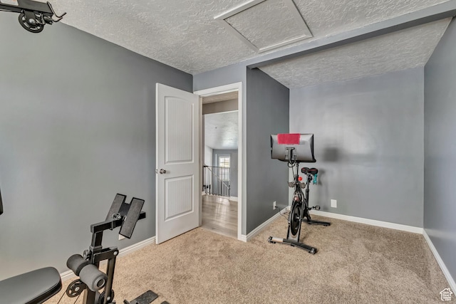 2683 S Melville Dr, Magna, UT 84044 - exercise area featuring baseboards, carpet floors, attic access, and a textured ceiling