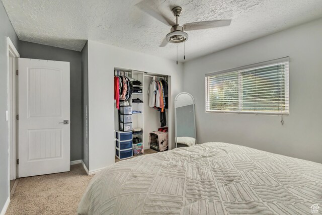 2683 S Melville Dr, Magna, UT 84044 - bedroom with a closet, a textured ceiling, light carpet, a ceiling fan, and baseboards