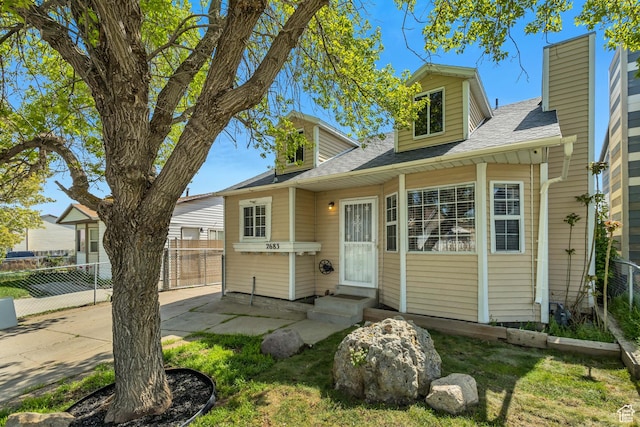 2683 S Melville Dr, Magna, UT 84044 - view of front of property featuring a chimney, roof with shingles, and fence