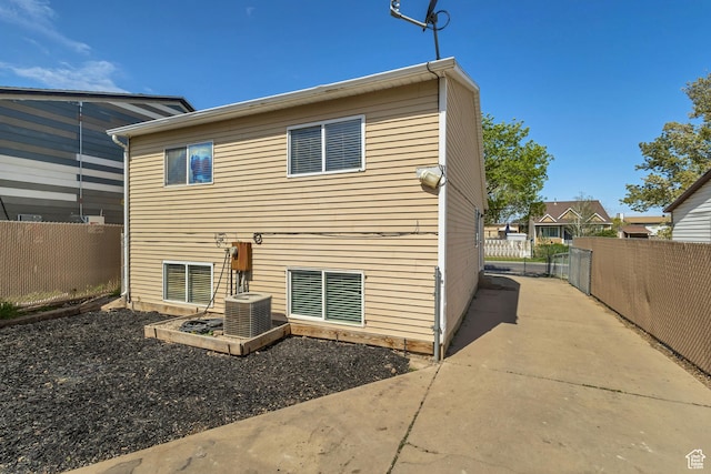 2683 S Melville Dr, Magna, UT 84044 - back of house with central AC, a patio, and fence