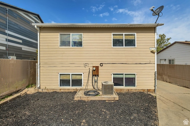 2683 S Melville Dr, Magna, UT 84044 - rear view of house featuring a fenced backyard and central AC