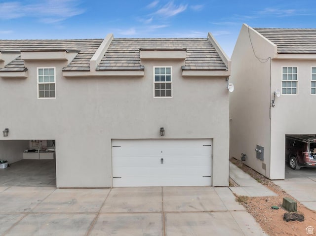4301 W Canterbury Rd, Hurricane, UT 84737 - rear view of property with driveway, stucco siding, and an attached garage