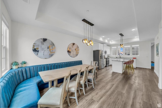 4301 W Canterbury Rd, Hurricane, UT 84737 - dining area with baseboards, recessed lighting, light wood-style floors, and a raised ceiling
