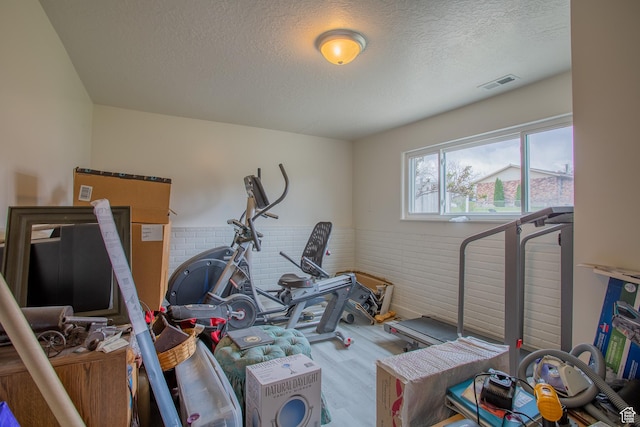 6100 W 3725 S, West Valley City, UT 84128 - workout area featuring a textured ceiling, visible vents, wainscoting, and wood finished floors