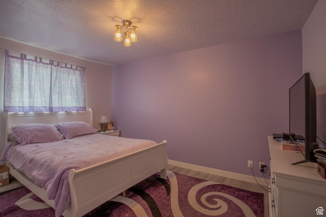 6100 W 3725 S, West Valley City, UT 84128 - bedroom featuring baseboards, wood finished floors, and a textured ceiling