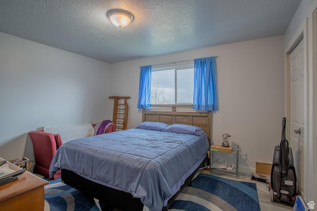6100 W 3725 S, West Valley City, UT 84128 - bedroom featuring baseboards and a textured ceiling