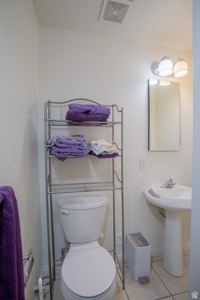 6100 W 3725 S, West Valley City, UT 84128 - bathroom with visible vents, baseboards, toilet, a sink, and tile patterned flooring