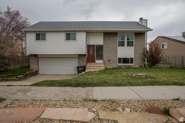 6100 W 3725 S, West Valley City, UT 84128 - bi-level home featuring brick siding, fence, and a front lawn