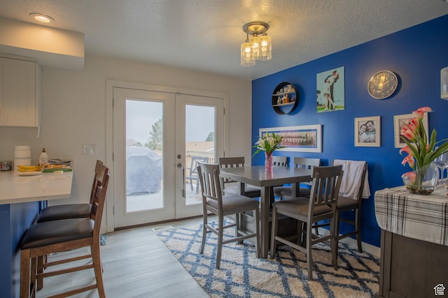 6100 W 3725 S, West Valley City, UT 84128 - dining area with a textured ceiling, light wood-style flooring, and french doors
