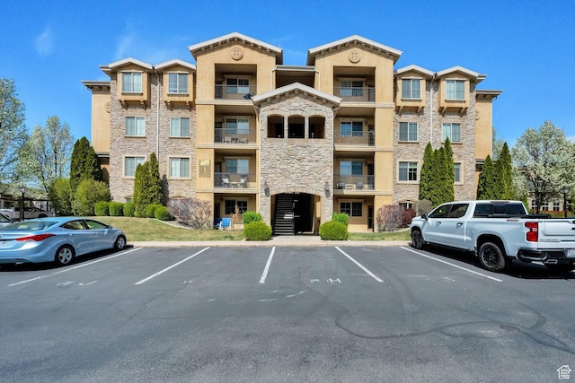 view of building exterior with uncovered parking