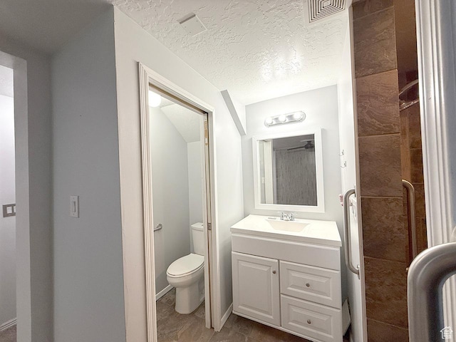 bathroom featuring visible vents, a textured ceiling, toilet, and vanity