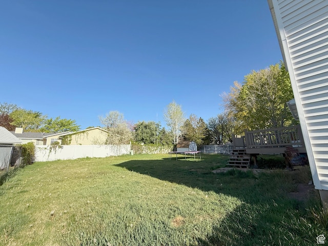 9294 S Vista W Dr W, West Jordan, UT 84088 - view of yard with a trampoline, stairs, fence private yard, and a deck