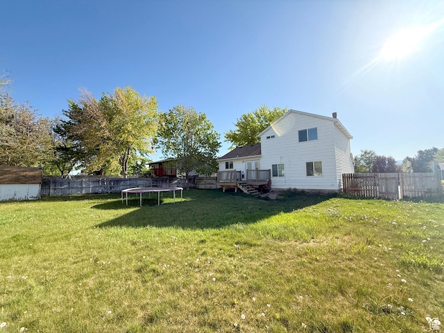 9294 S Vista W Dr W, West Jordan, UT 84088 - view of yard with a deck, a fenced backyard, and a trampoline