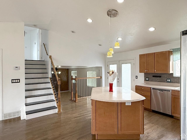 kitchen with visible vents, a center island, stainless steel dishwasher, brown cabinets, and wood finished floors