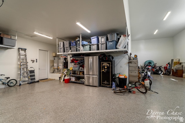 3169 S Pecos Dr, Washington, UT 84780 - garage with water heater and freestanding refrigerator